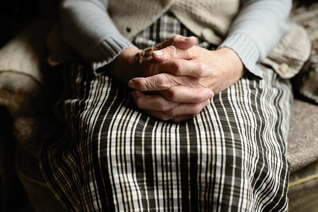 Close-up of a woman folding her hands in her lap