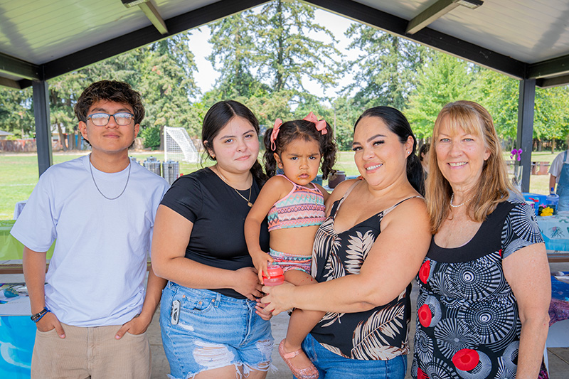 Lucille's Home Director Sharon with a former resident and her children at an event